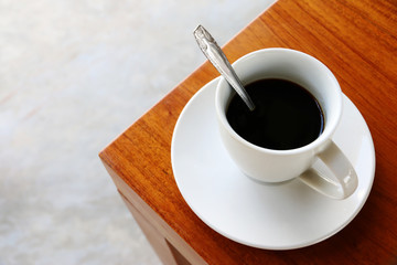 cup of hot coffee Americano on the wood table in coffee shop cafe