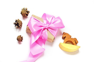 Flat lay gift box/ Winter holiday concept. Flat lay gift box with pink ribbon and bow, pine cone...