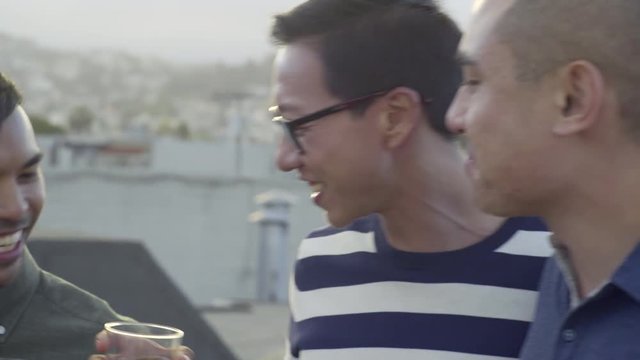 Gay Couple Chats At A Rooftop Party In San Francisco, Their Friends Join The Conversation 