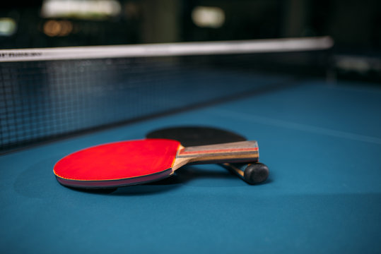 Red and black tennis rackets on table game concept