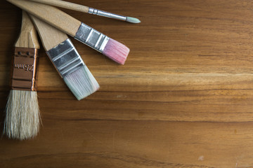 paint brushes on wooden table