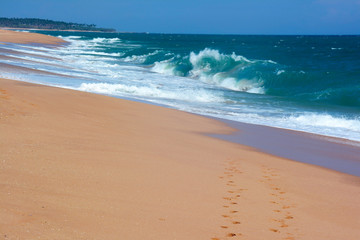 Two rows of the footprints on the sand paradise beach in Tangalle, Sri Lanka
