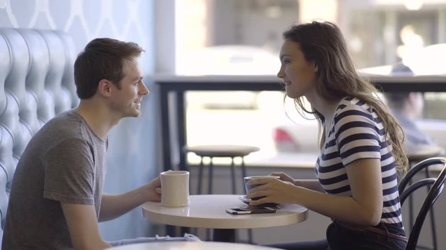 Happy Couple Enjoy Coffee, They Cheers And Share A Cute Moment Together