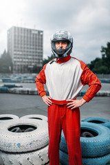 Kart driver with helmet in hands, Go-kart