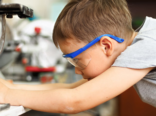 A boy makes a car model