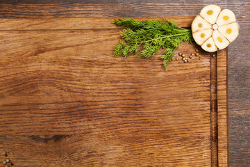 Garlic and dill with spices on cutting board preparation for cooking copy space background