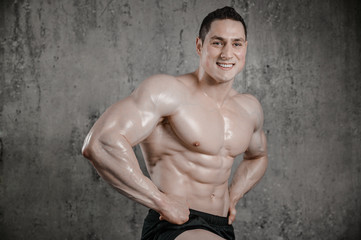 Fototapeta premium Brutal strong athletic men pumping up muscles