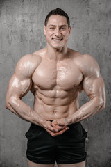 Brutal strong athletic men pumping up muscles