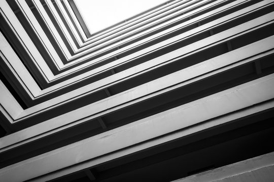 Top View Building, looking up to cement building. Modern architecture, cement Abstract architectural design. Inspirational, artistic image. Industrial design. .Modern building. Black and white.