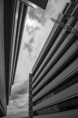 Fototapeta premium Top View Building, looking up to cement building. Modern architecture, cement Abstract architectural design. Inspirational, artistic image. Industrial design. .Modern building. Black and white.
