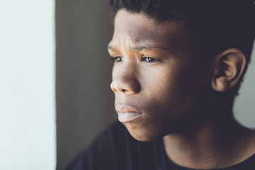 Faded retro portrait of a worried African boy
