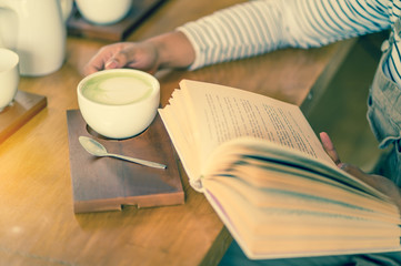 woman reading book in coffee shop