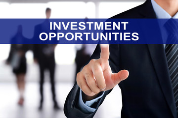 Businessman hand touching INVESTMENT OPPORTUNITIES sign on virtual screen