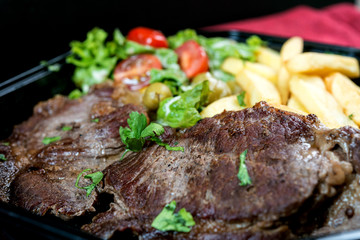 juicy steak beef meat with tomato and french fries