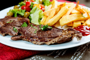 juicy steak beef meat with tomato and french fries