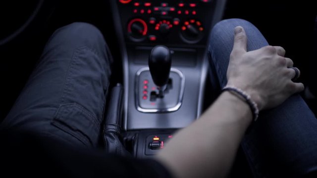 Tender Moment Between A Couple On A Drive, They Hold Hands 