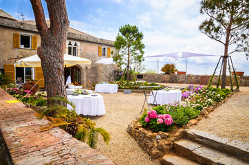 Restaurant tables in the yard of castle Brown in Portofino,  Liguria, Italy