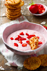 Strawberry cheesecake dip with cookies .