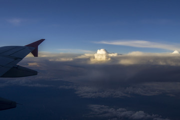 Fototapeta na wymiar Through the windows of an airplane overlooking sunset on high altitude.