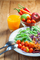 Healthy concept with mixed fruits and vegetables on wooden background