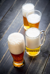 Beer glasses with various beer on old wood table