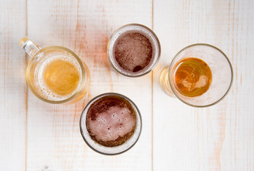 Beer glasses with various beer on wood table,top view