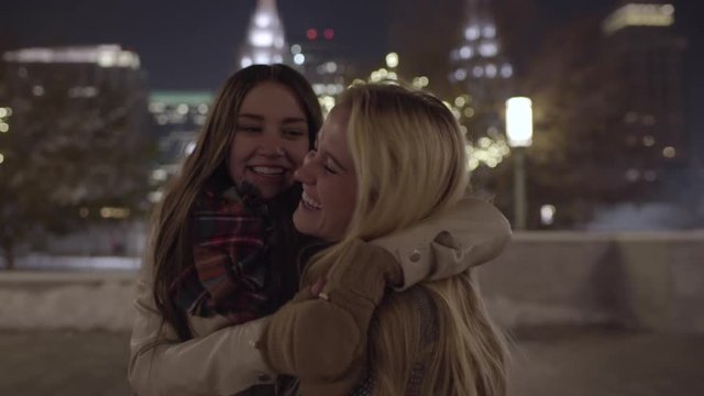 Happy Young Women Hug And Laugh (LDS Temple In Background) In Downtown Salt Lake City