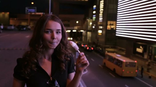 Girl eating ice cream at night