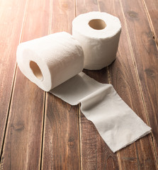 roll of toilet paper on a wooden background