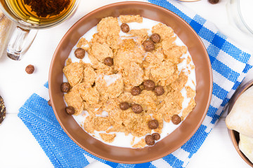 Top view of healthy breakfast. Oat cereal granola in bowl on white wooden background