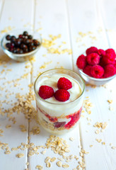 Dessert with berries of raspberries and blueberries on a wooden background