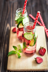 Detox water infused with fruits. Summer water fruit on rustic background