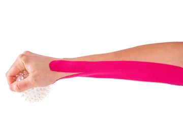hand with kinesiology tape and stressball. 
