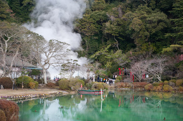 Hot spring water (Hells), the "sea hell" features a pond of boiling and red torii gateway in Umi Jigoku at Beppu, Oita-shi, Kyushu, Japan
