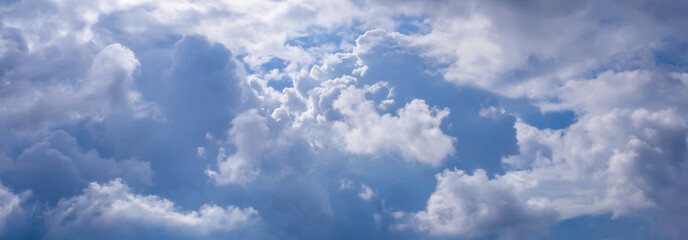 Naklejka na ściany i meble Cloudy on blue sky with lens flare,Pamoramic view,A lot of clouds
