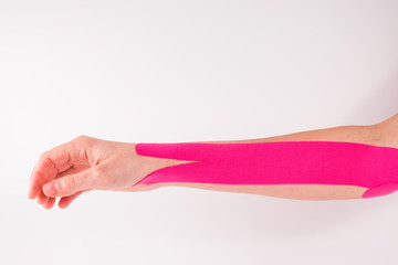 hand with kinesiology tape. Physiotherapy and herapeutic tape for wrist pain, aches and tension.