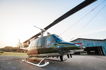 The image blurred of Army Helicopter parking at the hangar in the morning with sunrise.