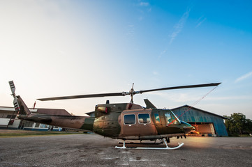 The image blurred of Army Helicopter parking at the hangar in the morning with sunrise.