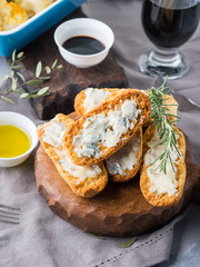 Italian toasts with gorgonzola cheese on rustic background with wine