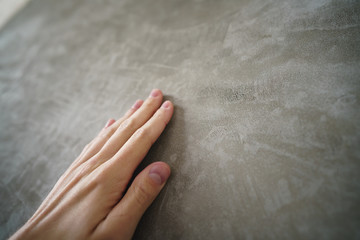 young man hand touching concrete wall - obrazy, fototapety, plakaty