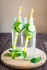 Detox water infused with mint and cucumber. Summer water fruit on rustic background