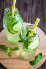 Detox water infused with mint and cucumber. Summer water fruit on rustic background