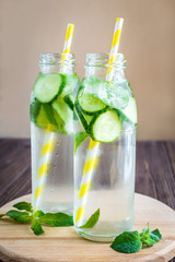 Detox water infused with mint and cucumber. Summer water fruit on rustic background