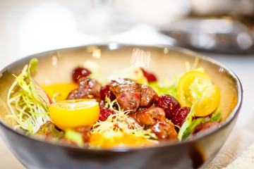The chicken liver salad tomato and physalis is in the bowl.