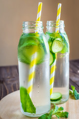 Detox water infused with mint and cucumber. Summer water fruit on rustic background