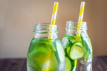 Detox water infused with mint and cucumber. Summer water fruit on rustic background