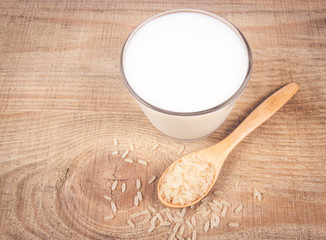 Rice milk on the wooden background .