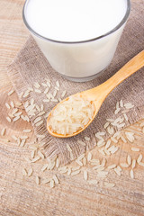 Rice milk on the wooden background .