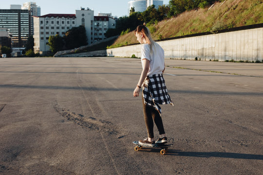 Hipster girl riding skate board