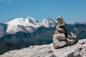 Stones Piled on Each Other and Mountain Ridge in Italian Dolomites Alps in Summer Time in Background